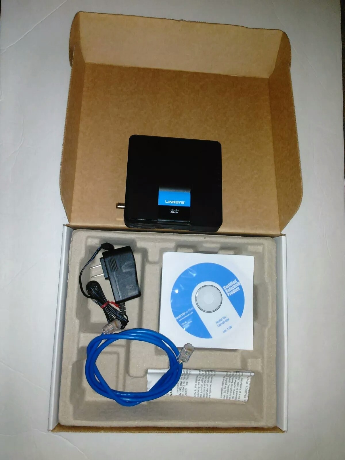 Linksys Cisco CM100 Refurbished Cable Modem With Power Cord Ethernet Cable CD