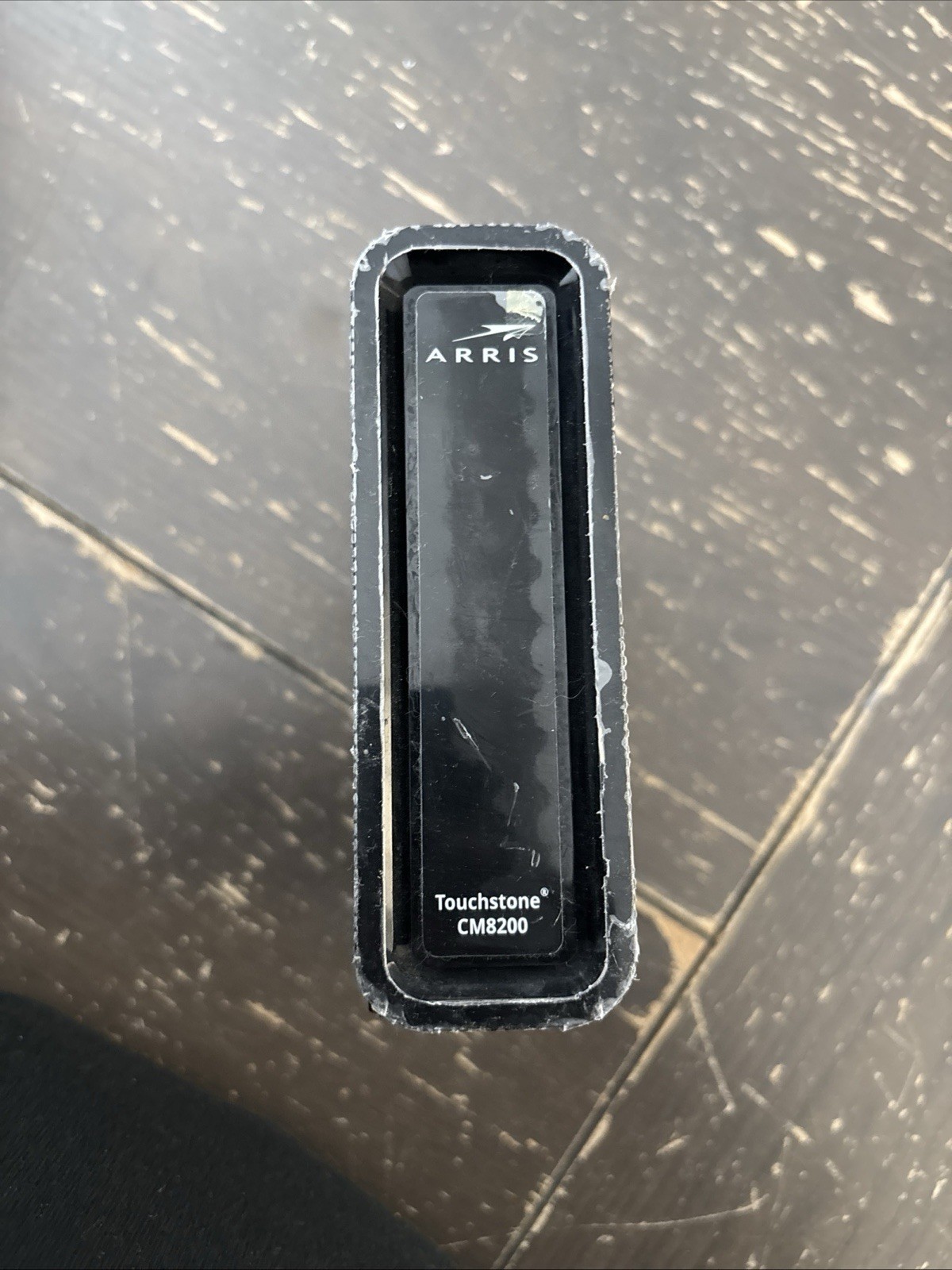 The item shown is an ARRIS Touchstone CM8200A cable modem