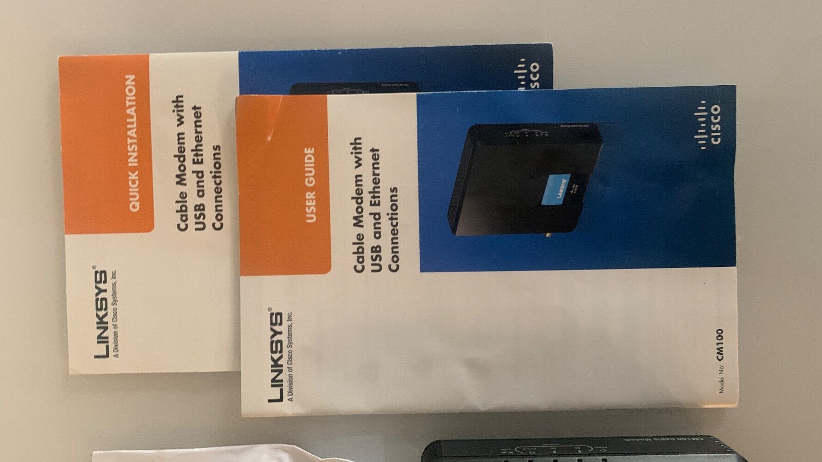 Cisco Linksys CM100 Cable Modem with power adapter, 2 manuals, CD, USB cable