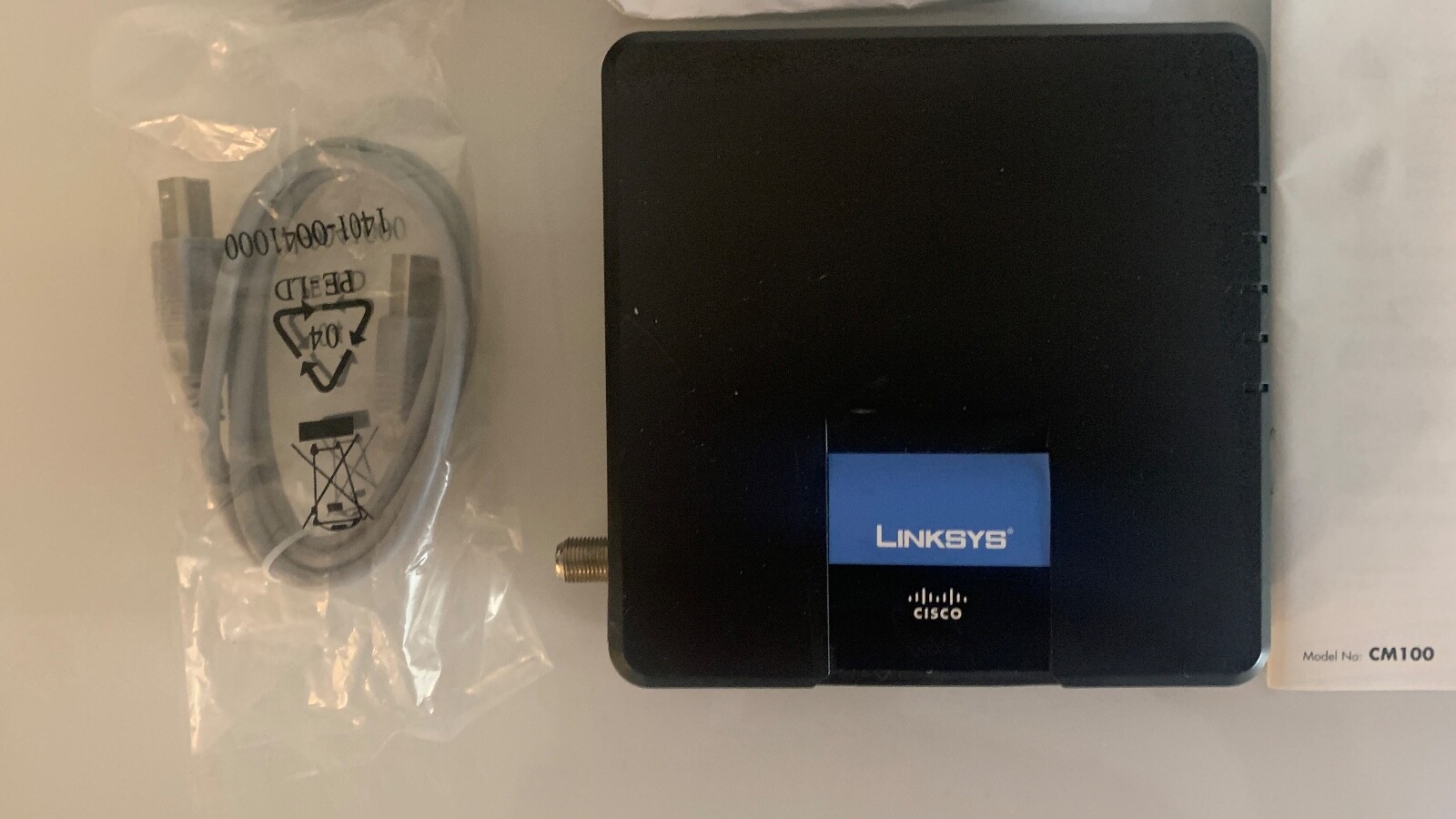 Cisco Linksys CM100 Cable Modem with power adapter, 2 manuals, CD, USB cable